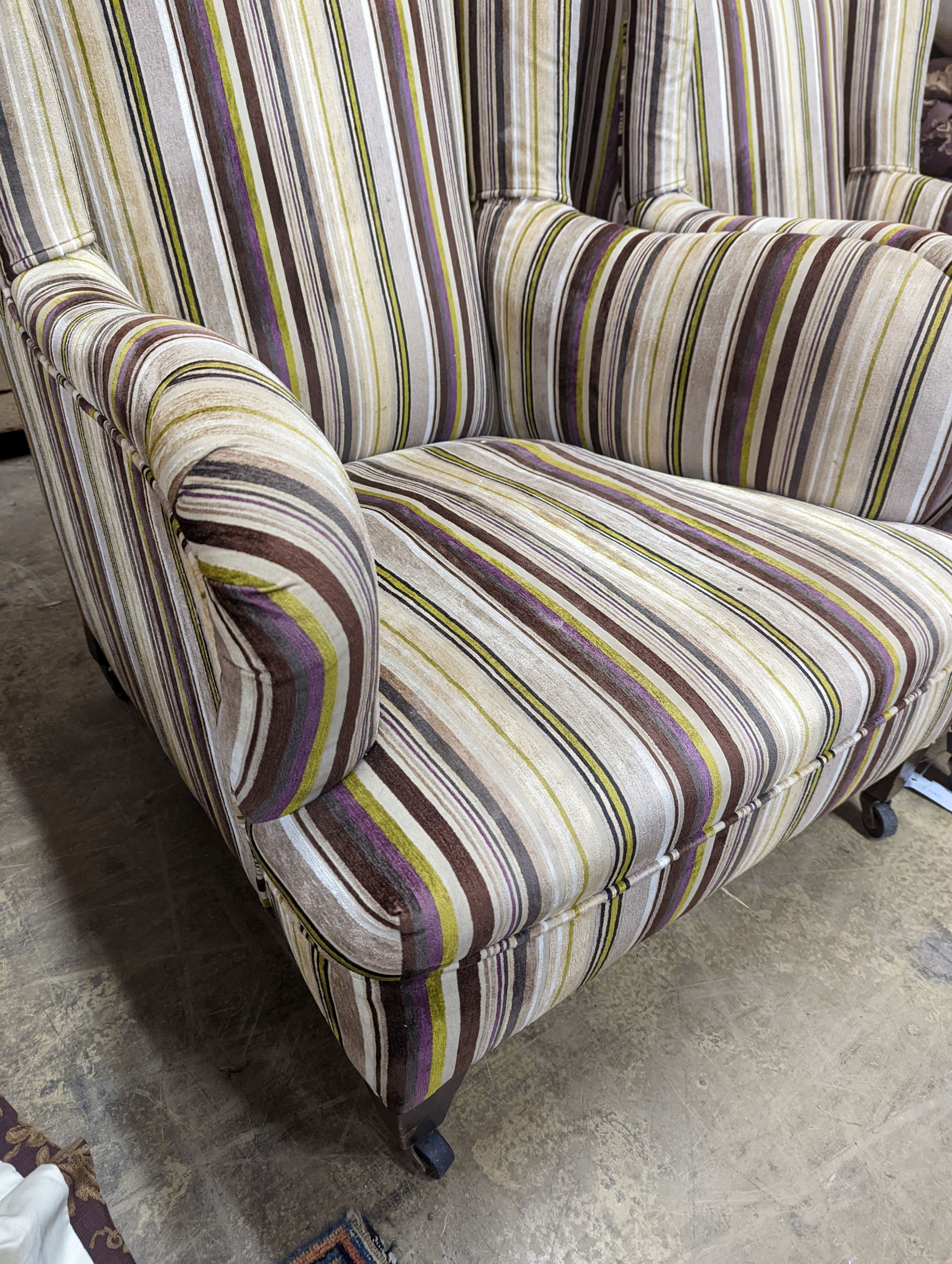 A pair of late Victorian Howard & Sons style armchairs, recently re-upholstered in a contemporary striped fabric, width 76cm, depth 88cm, height 87cm